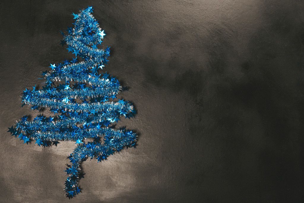 Blue Christmas tree on a dark background with free space (Flip 2019)
