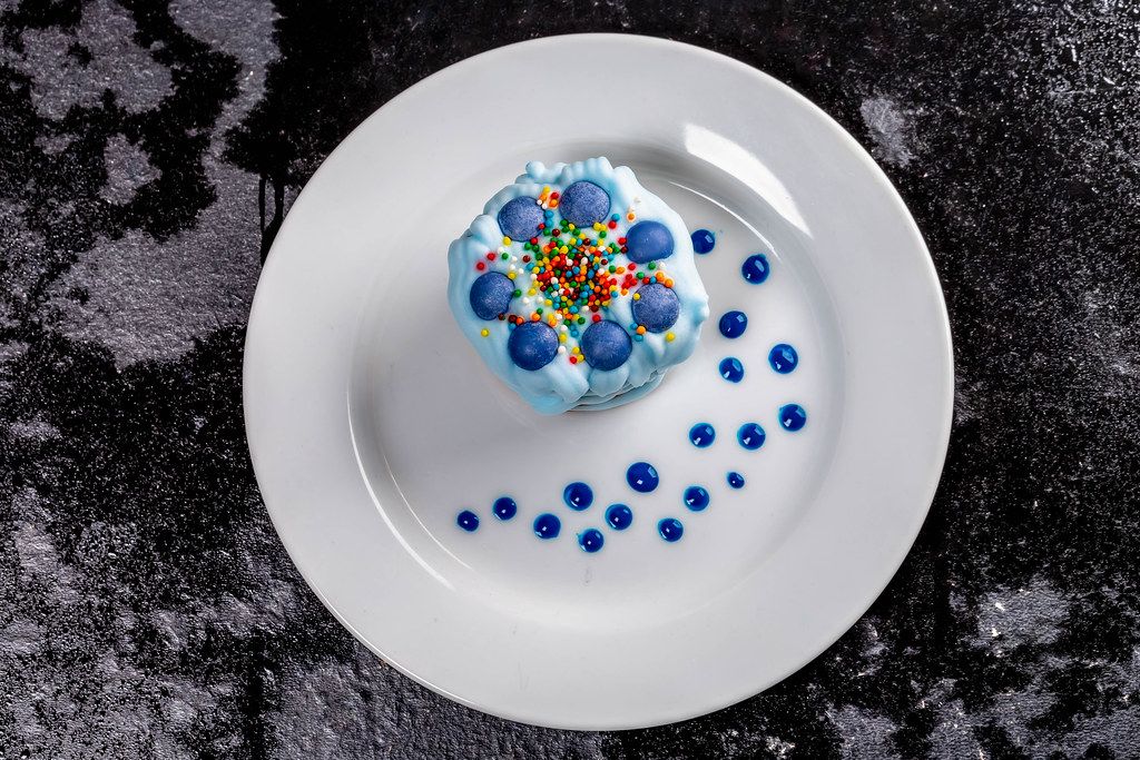 Blue dessert with multi-colored powder and blue cream (Flip 2019)