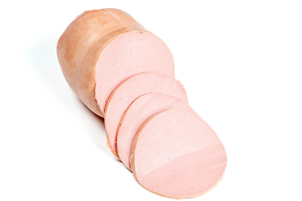 Boiled sausage sliced on white background