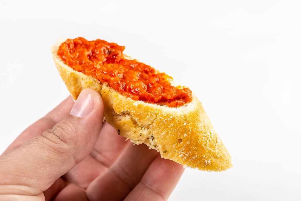 Bread Baguettes with Tomato and Tartar Sauce in the hand