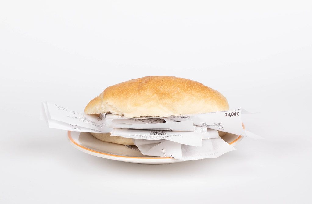 Bread roll full of receipts on white background