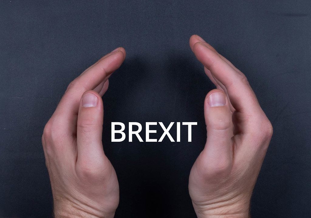 Brexit text with man hands on black bacground