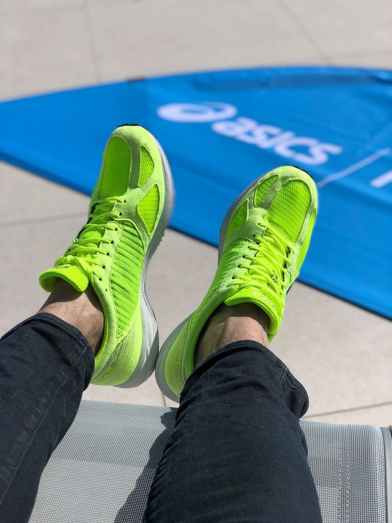 Brightly colored green ASICS running shoes