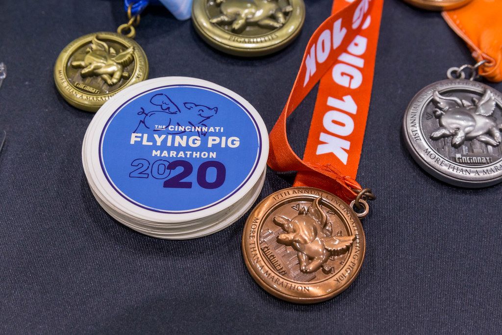 Bronze-, silver-, and gold medals next to patches of the Cincinnati Flying Pig Marathon 2020