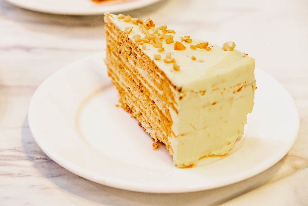 Butter-creamed cake slice on marble white table (Flip 2019)