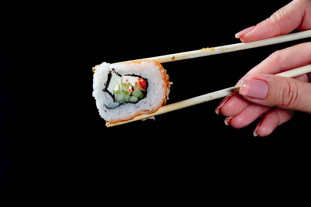 California Sushi roll keeps in chopsticks girl