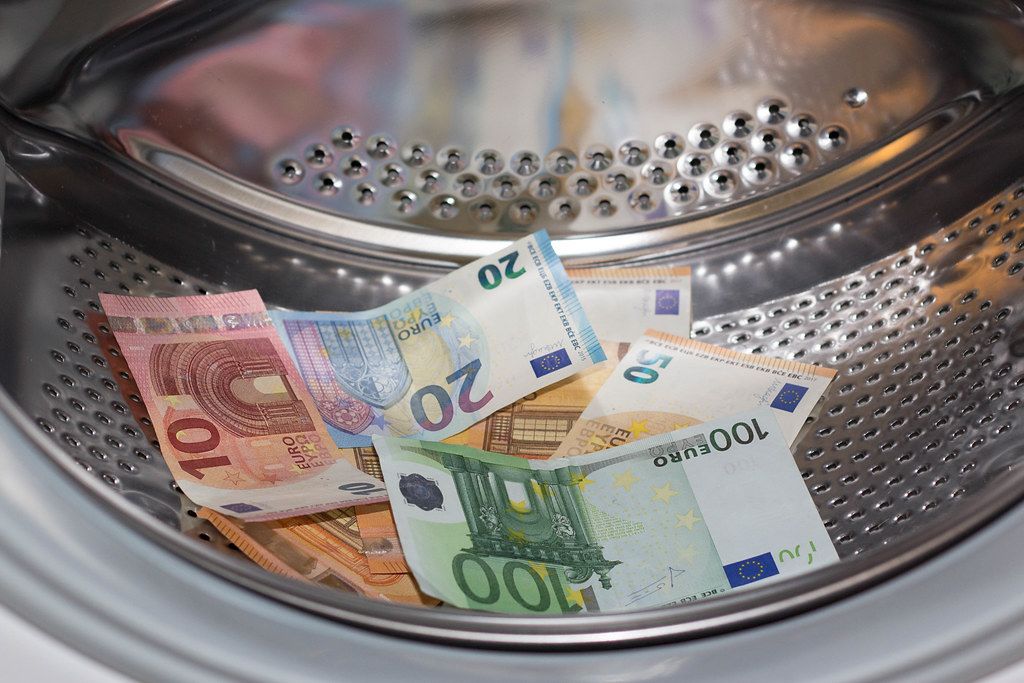 Cash in a tumbler symbolising money laundering