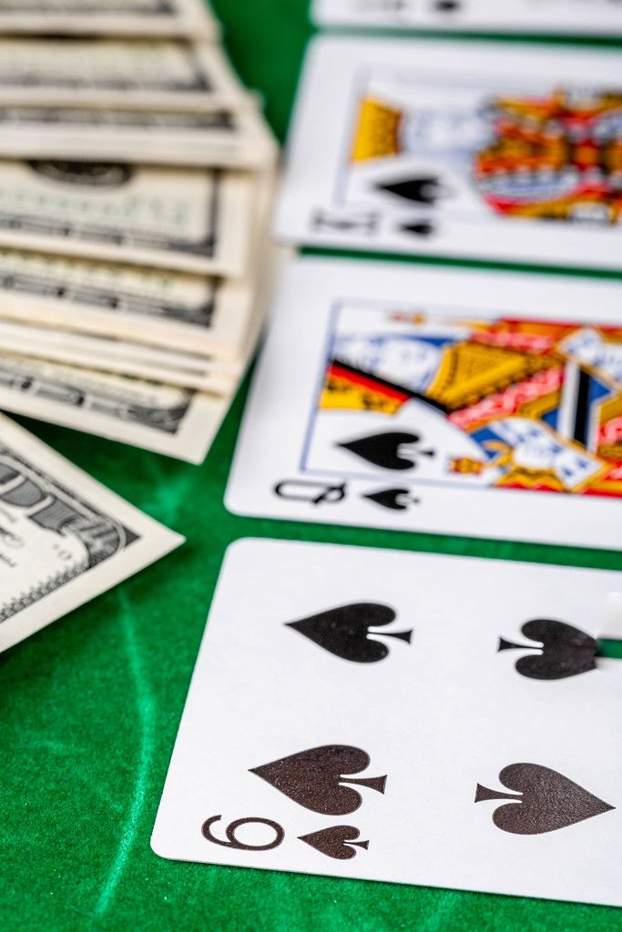 casino-gambling-poker-cards-and-money-on-green-desk-background.jpeg