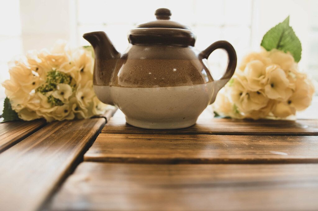 Ceramic brown teapot on a wooden surface