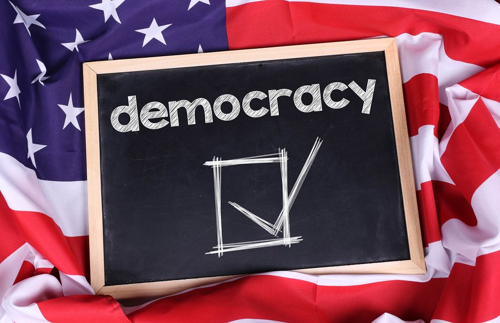 Chalkboard with Democracy text on American flag.jpg