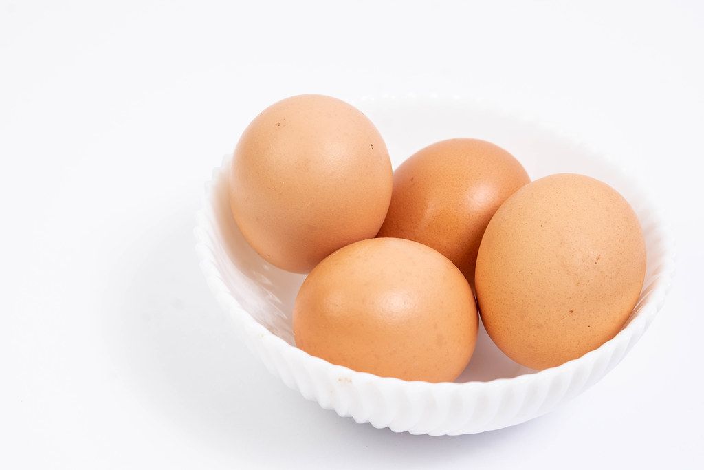 Chicken Eggs in the bowl above white background