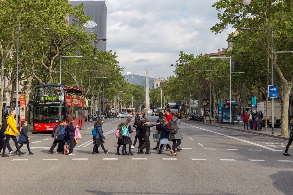 Children crossing the street in the city centre of Barcelona