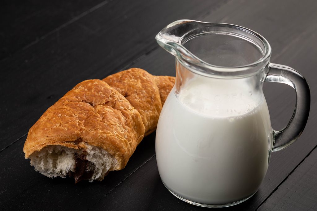Chocolate croissant with milk on the black board