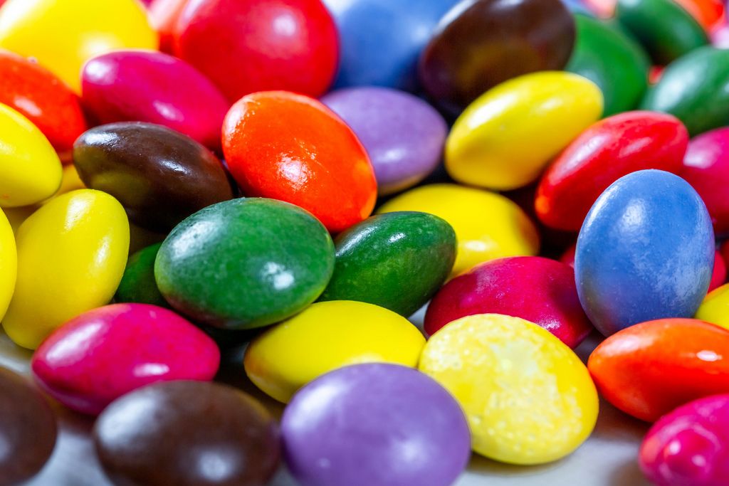 Chocolate small candies in multi-colored glaze