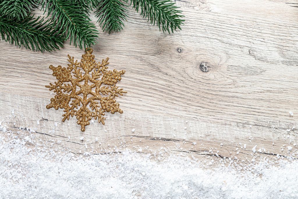 Christmas background with Christmas tree branches, snow and golden snowflake (Flip 2019)