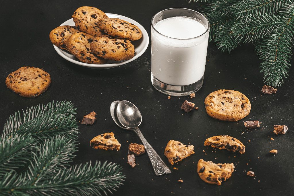 Christmas background with glass of milk and homemade chocolate cookies