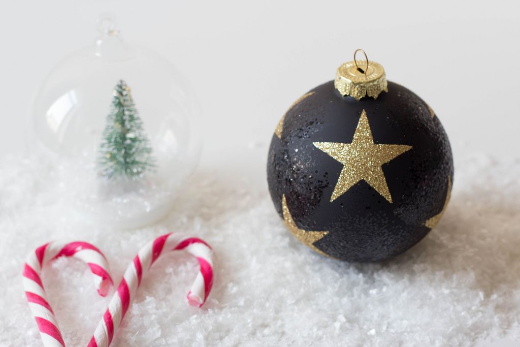 Christmas ball on snow with sugaar sticks