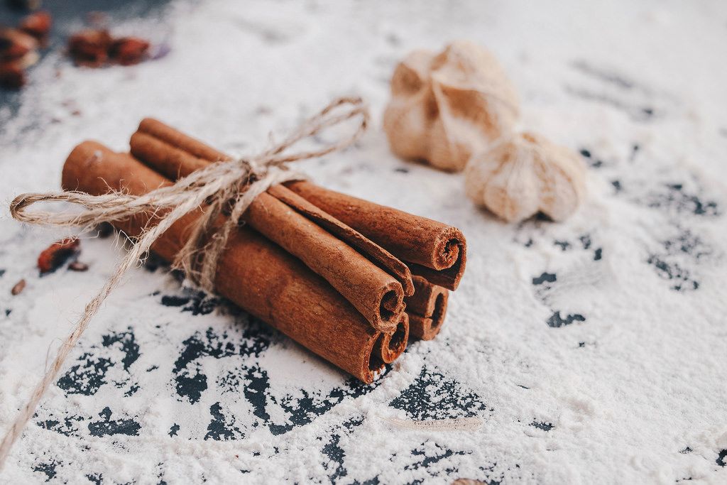 Cinnamon sticks in close up with flour background