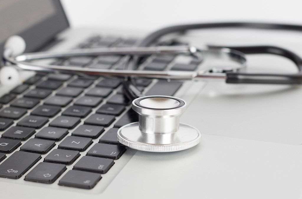 Close Up Bokeh Photo of Stethoscope placed on laptop keyboard