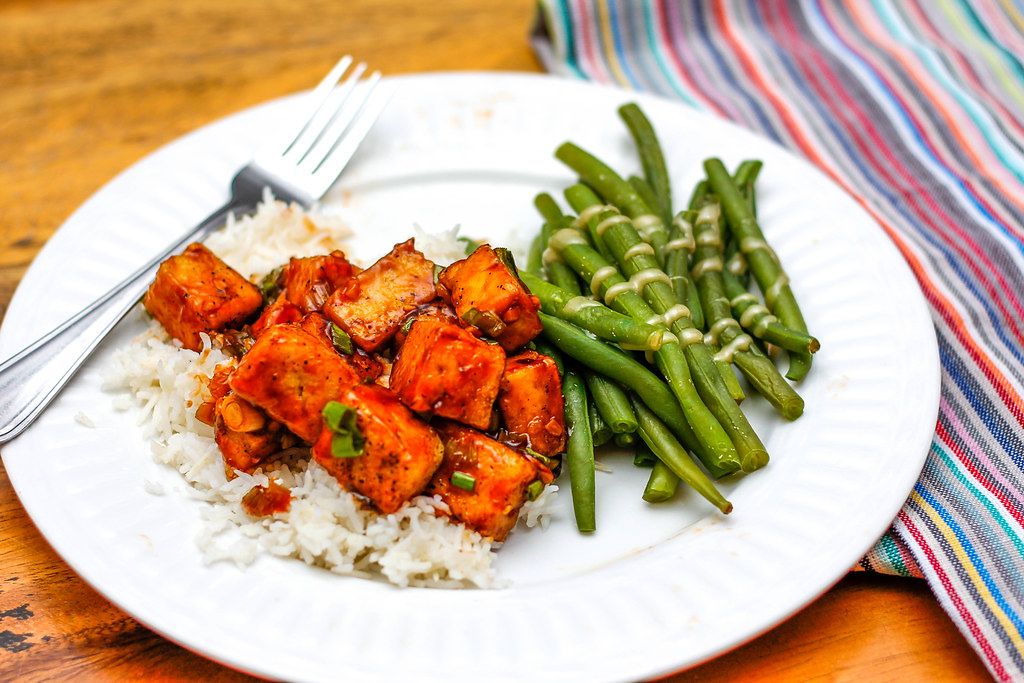 Close Up Food Photo of Asian Dish with Rice, Marinated Tofu and Green Beans on White Plate