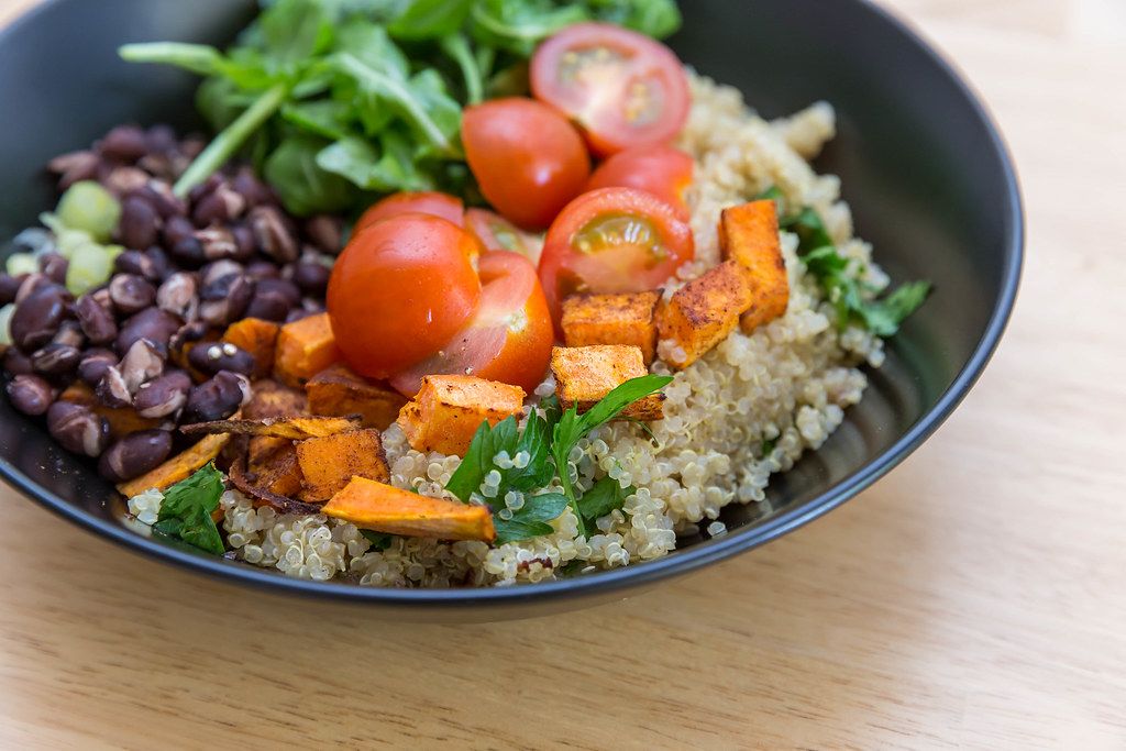Close Up Food Photo of Healthy Vegan Bowl with Sweet Potatoes, Red Beans, Cherry Tomatoes and Arugula