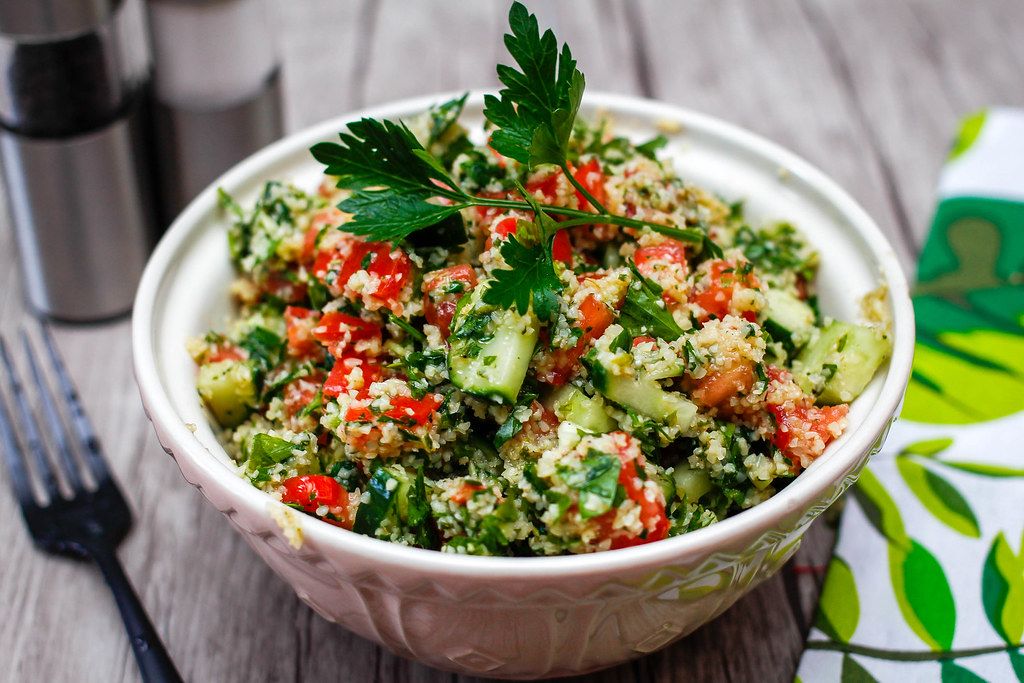 Close Up Food Photo of Lebanese Tabbouleh Salad Bowl on a Wooden Table