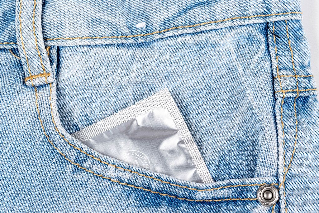 Close- up of a condom in a jeans pocket
