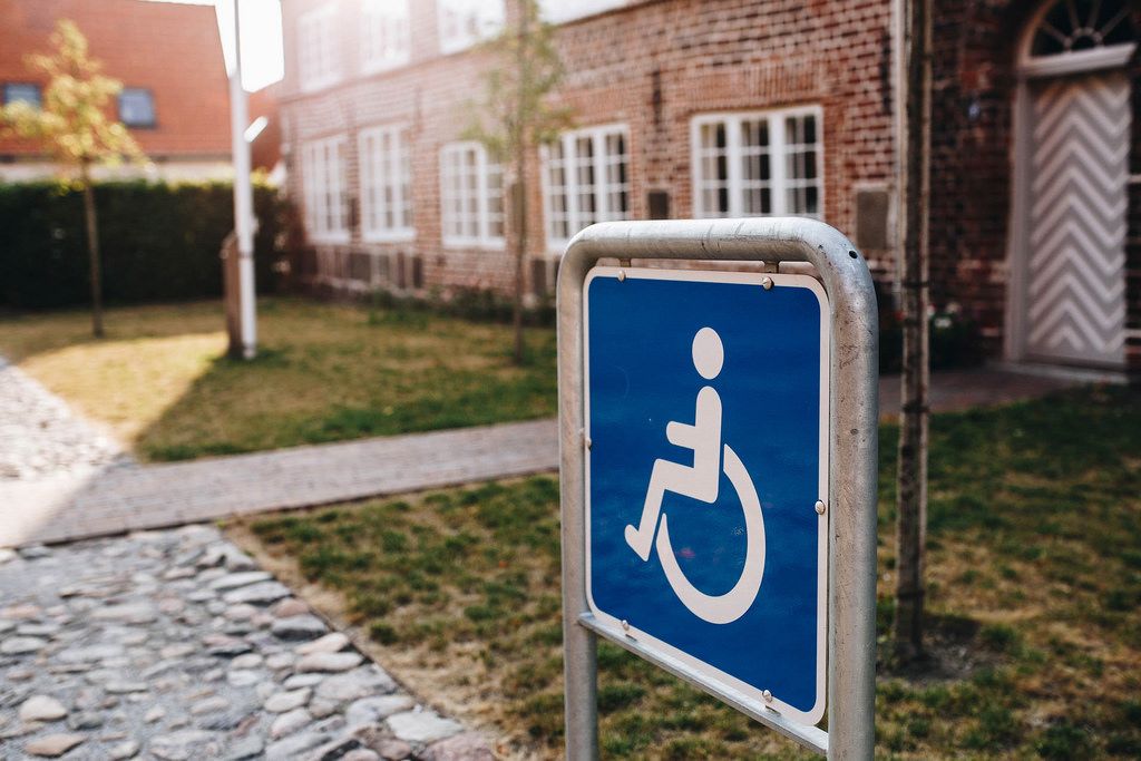 Close up of disabled sign on the street. Building in the background