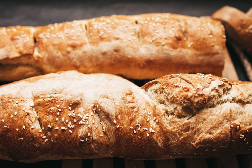 Close up of french baguette with sesame on dark background