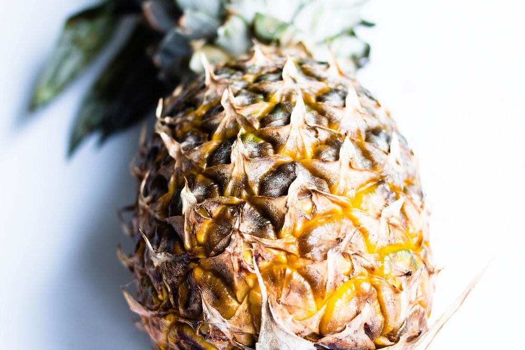 Close up of fresh ripe pineapple on white background