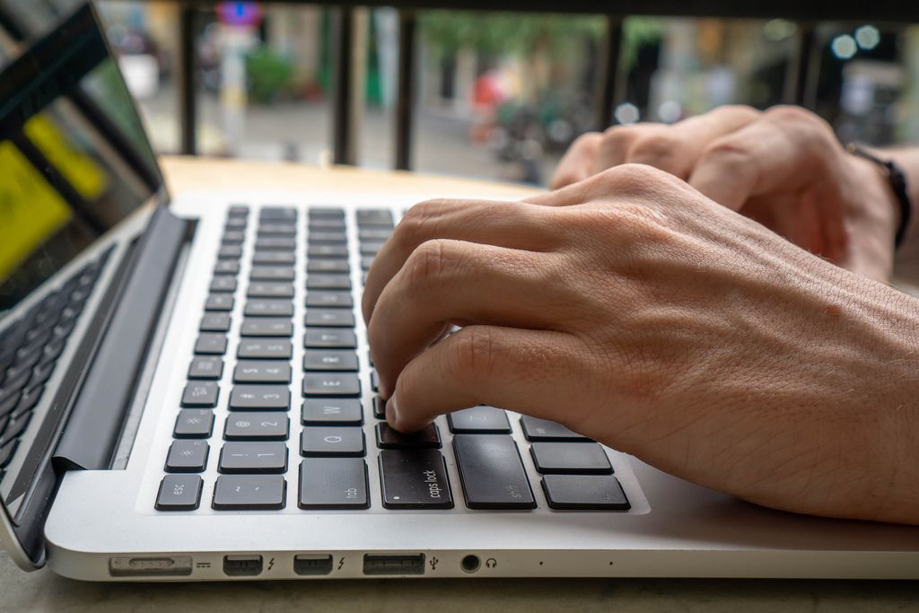 Close Up of Hands on a Laptop Keyboard