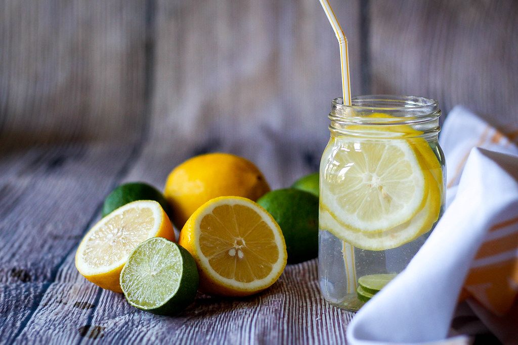 Close Up of Healthy Lemon Lime Drink in a Glass with Straw