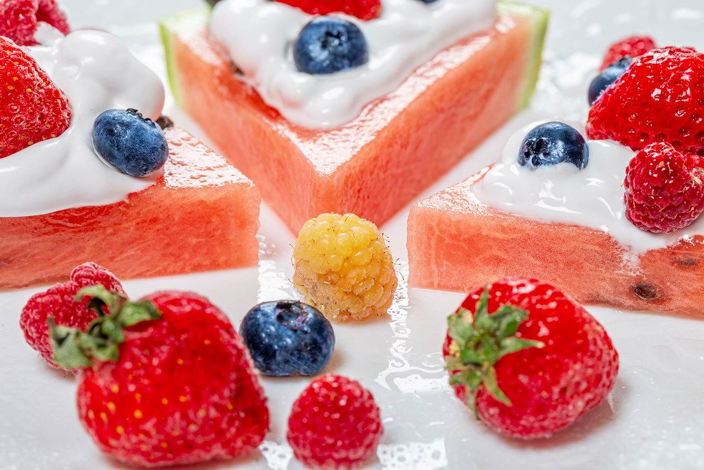 Close-up of strawberries, raspberries, blueberries and watermelon-fruit dessert with cream (Flip 2019)
