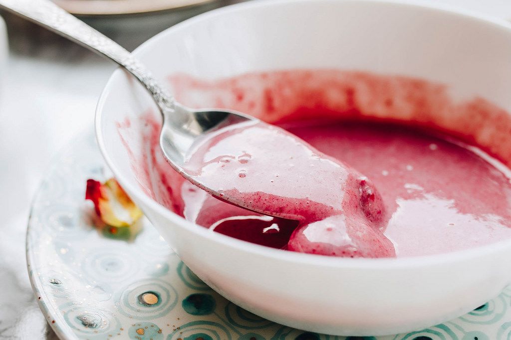 Close up of strawberry smoothie in a spoon. Healthy food