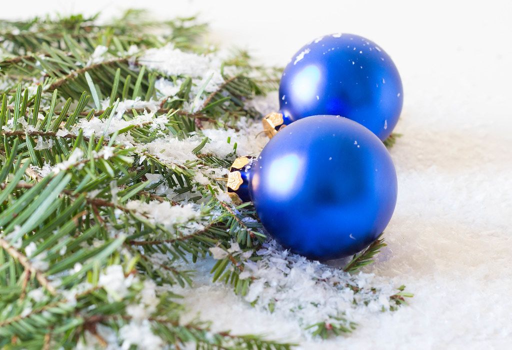 Close Up Photo of Blue Christmas Tree Balls on Artificial Snow