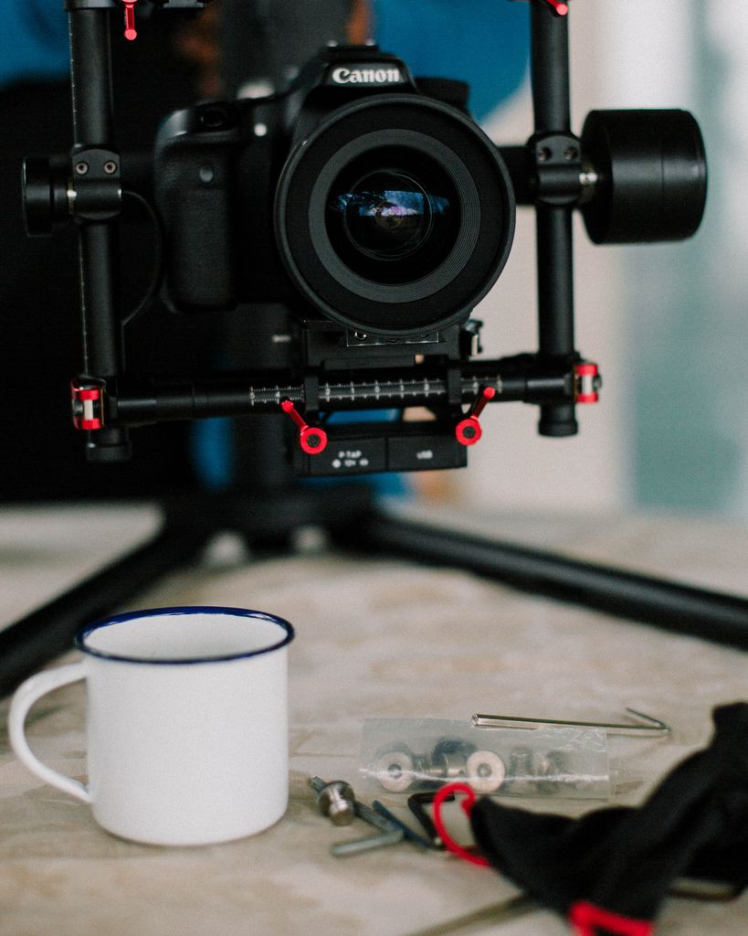 Close Up Shot of Coffee Mug and Camera on a Stabilizer