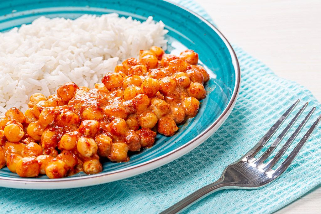 Closeup chickpeas in tomato sauce with rice (Flip 2019)