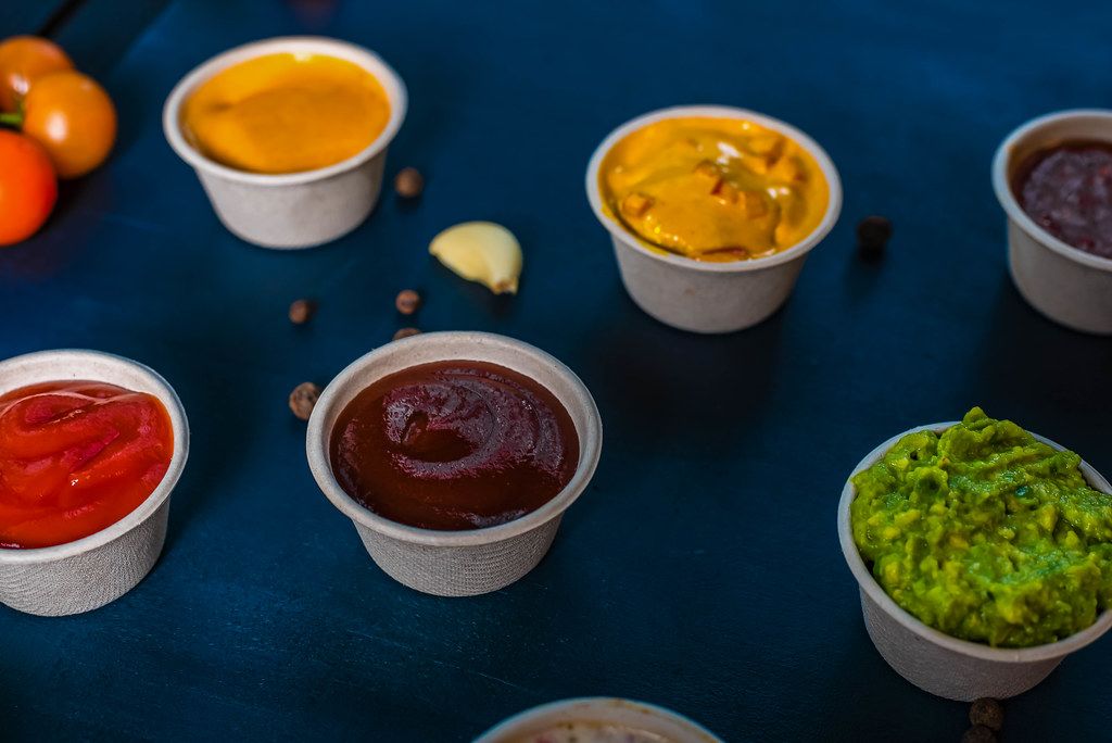Closeup of appetizer sauces. Ketchup. (Flip 2019)