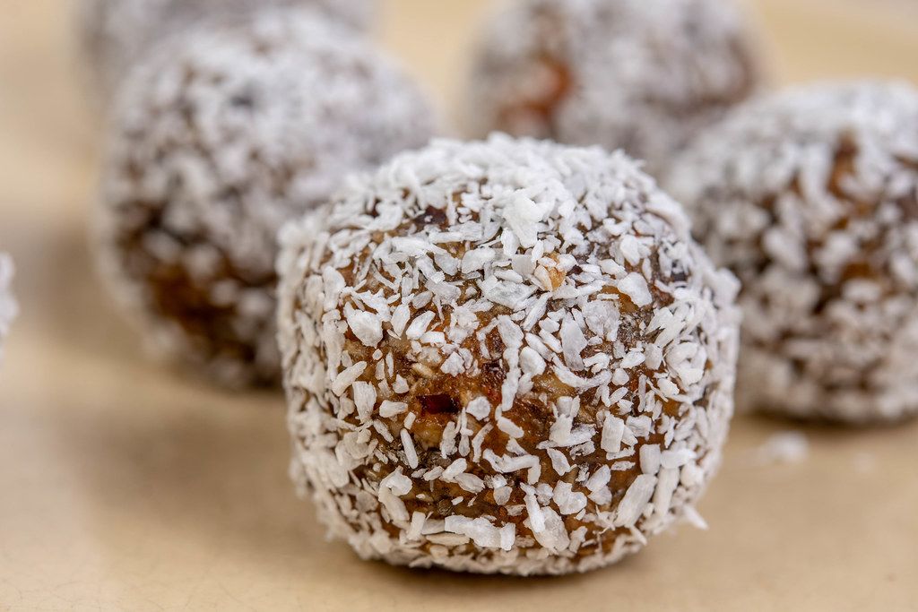 Closeup of Dates and Peanut Butter energy balls in the Coconut