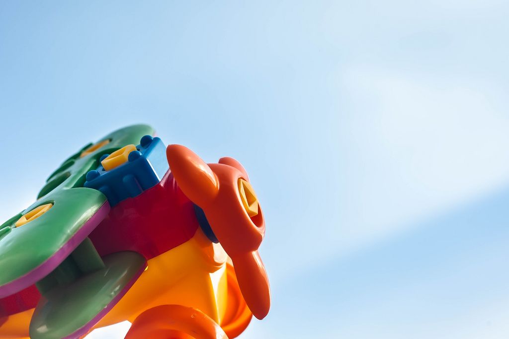 Closeup view of plastic toy plane against clear blue sky