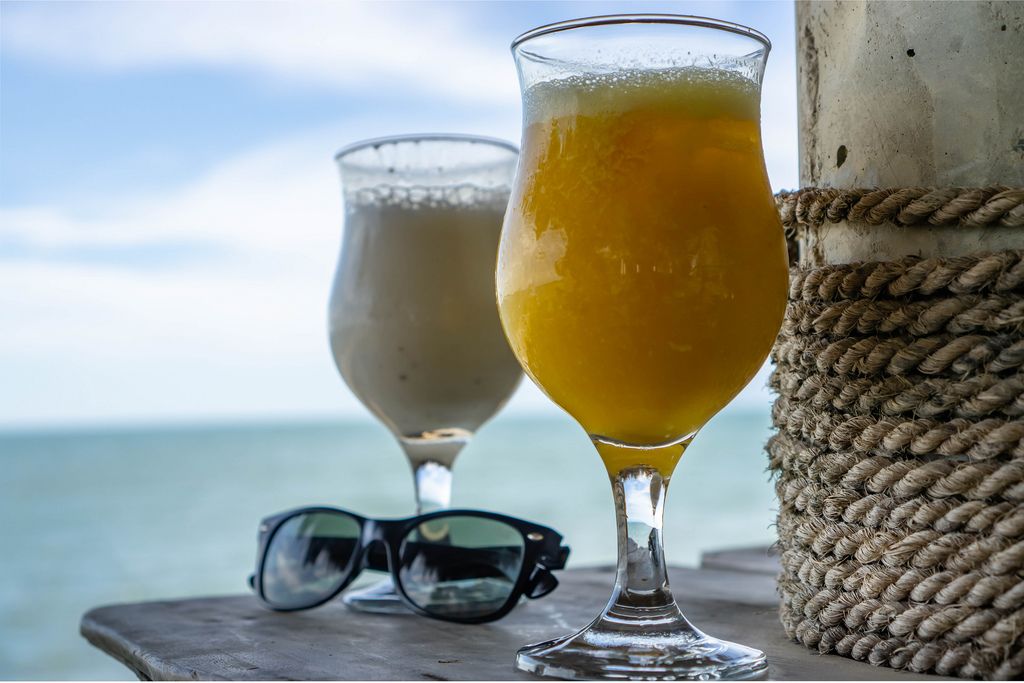 Cocktails and Sunglasses on a Table with Seaview in the Background (Flip 2019) (Flip 2019) Flip 2019