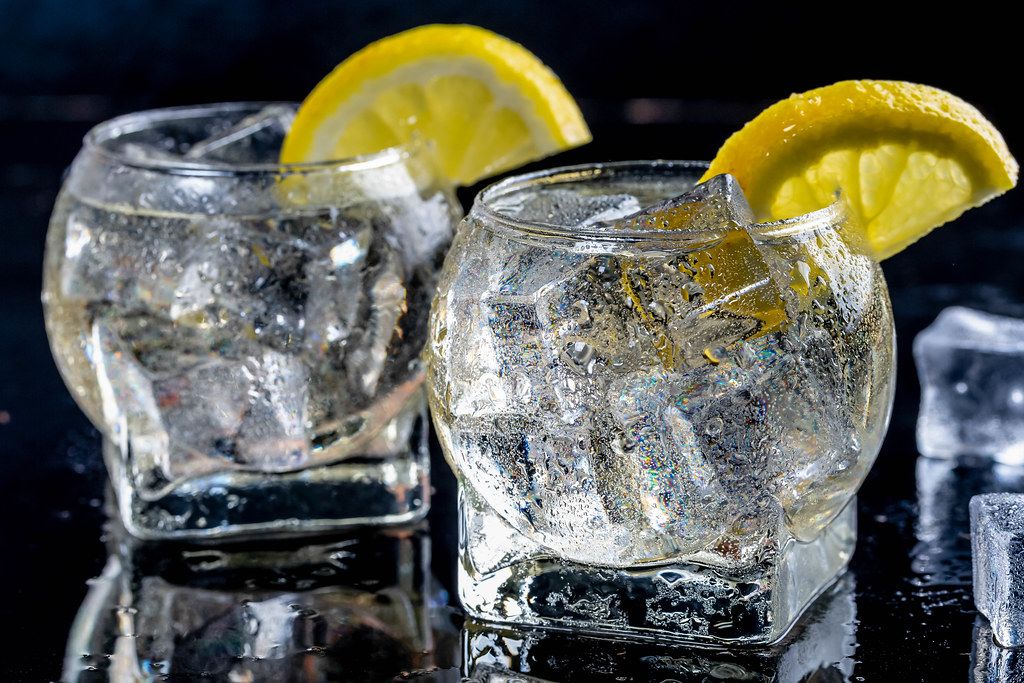 Cold lemonade with ice cubes on black background (Flip 2019)
