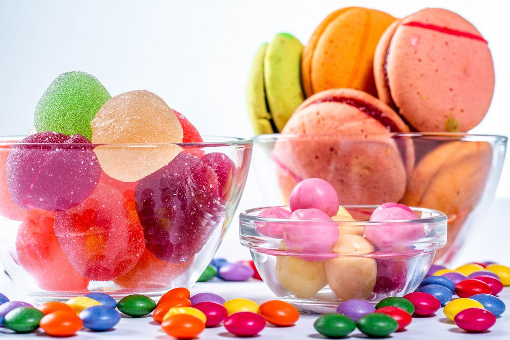 Colored cookies and candies on white background