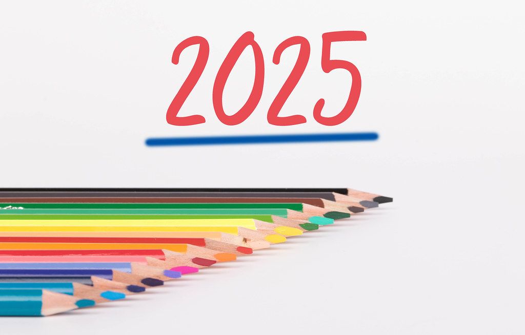 Colorful pencils on white background with text 2025