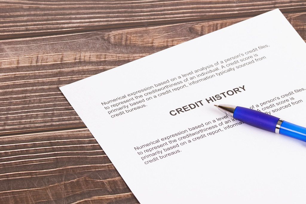 Credit history document with pencil on wooden table