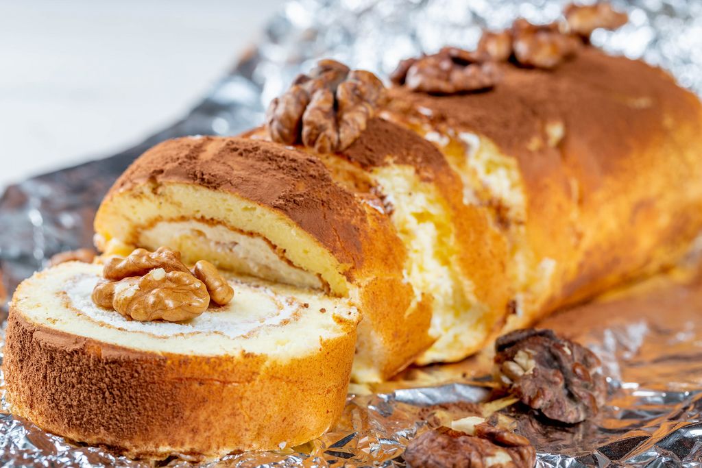 Cut pieces of sponge cake roll decorated with walnuts