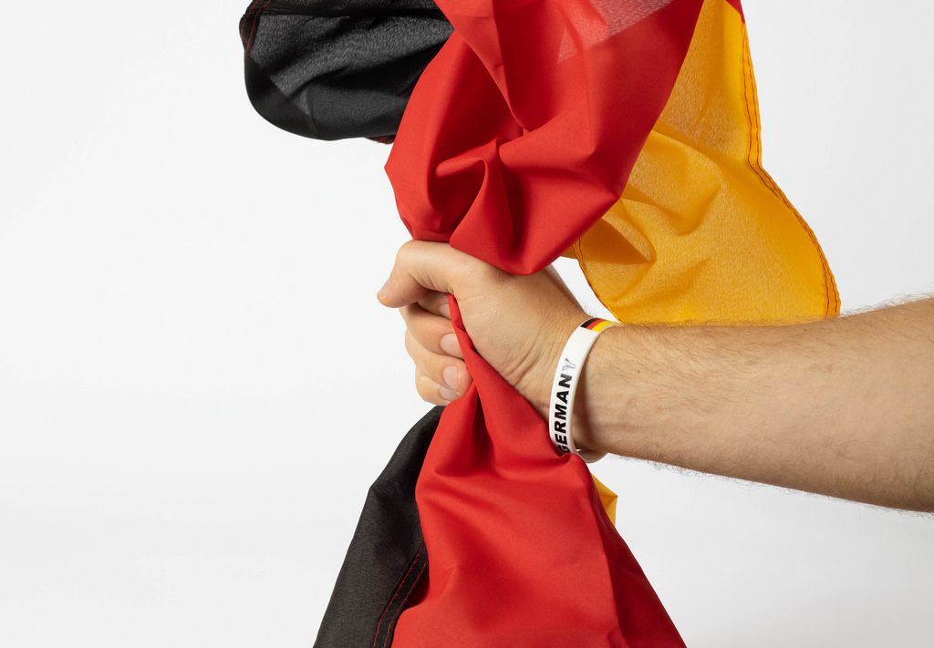 Deutscher Fußball-Fan hält deutsche Flagge in der Hand