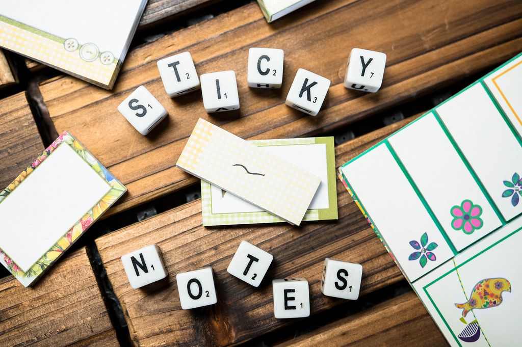 Dice reading STICKY NOTES with sticky notes around