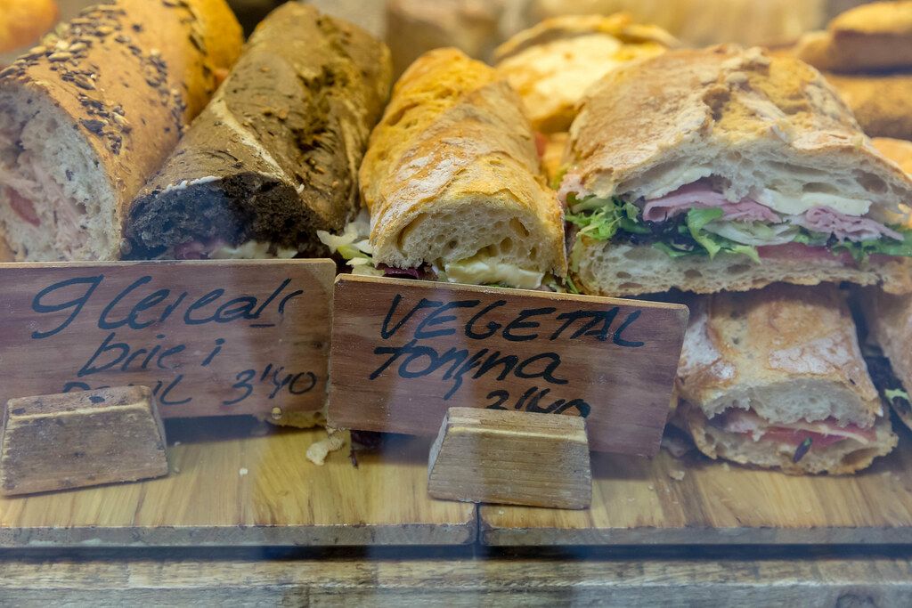 Diverse country-stil breads with salad, sausage, cheese and vegetables in Barcelona, Spain