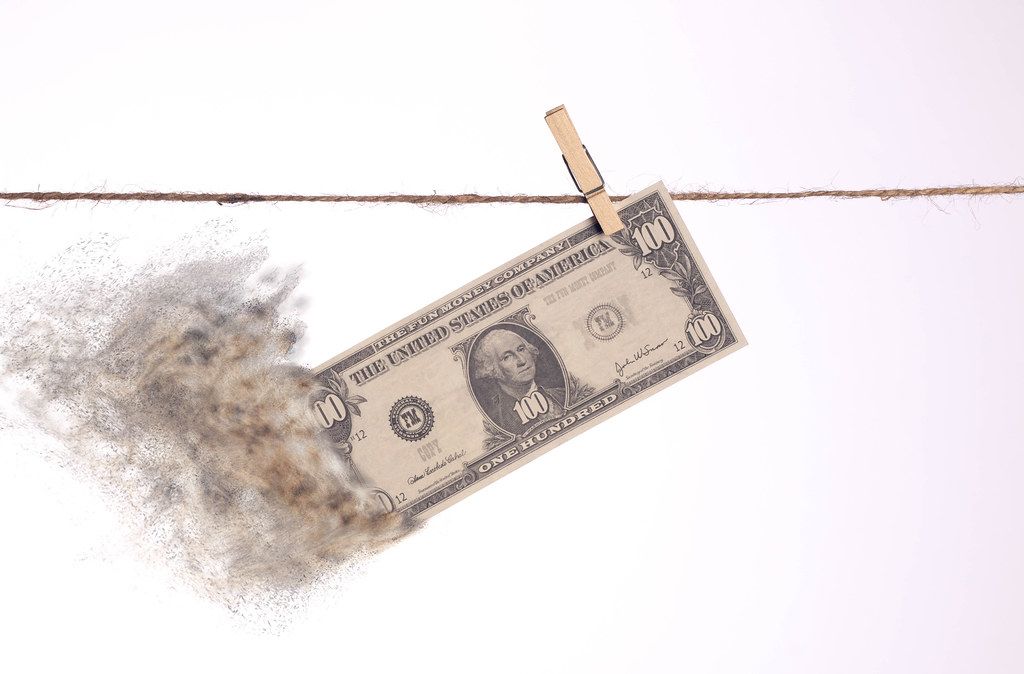 Dollar banknote with smoke hanging on clothes line